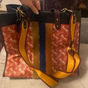 Beautiful leather Coach bag with mustard yellow shoulder strap. Suede interior.